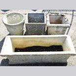 A cast stone garden trough, 97cm wide with three various garden pots (4)