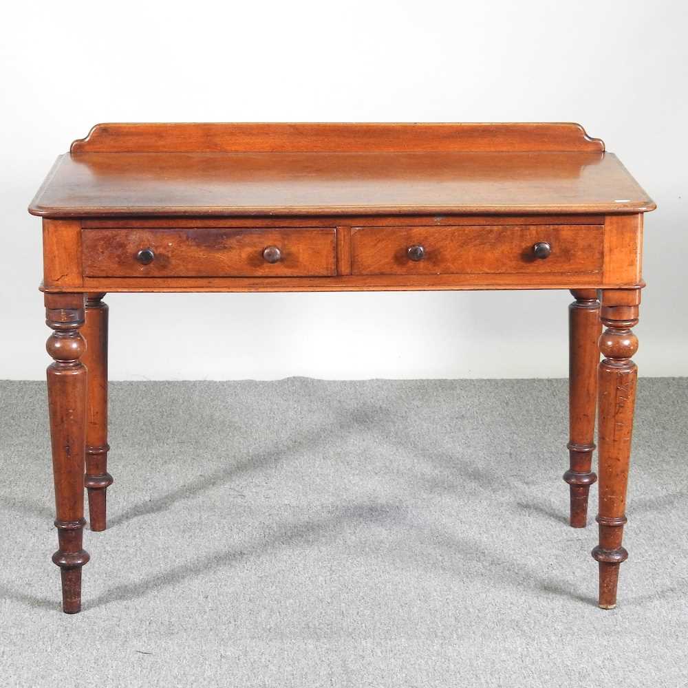 A Victorian mahogany side table, with a gallery back, on a turned legs 106w x 75h x 52d cm