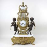 An ornate continental style gilt marble clock, of lyre shape, flanked by bronzed cherubs, 35cm high