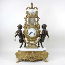 An ornate continental style gilt marble clock, of lyre shape, flanked by bronzed cherubs, 35cm high