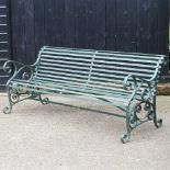 A large hand forged green painted cast iron garden bench, 184cm wide