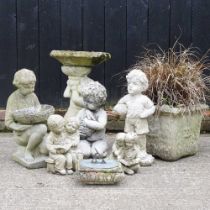 A cast stone bird bath, together with a collection of cast stone garden ornaments