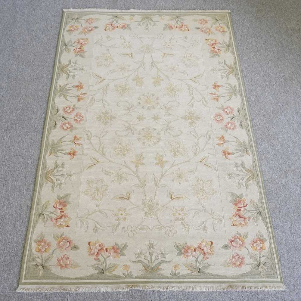 A kashan style rug, with all over floral and foloiate motifs, on a pale ground, 170 x 110cm