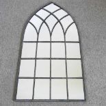 A tall arched Gothic style outdoor mirror