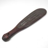 A Maori hardwood short paddle, carved in low relief with geometric designs, 39cm long