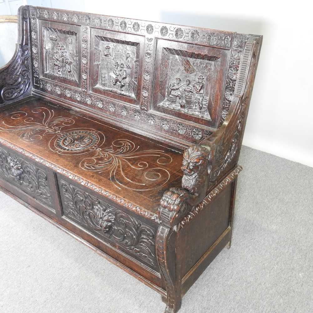 A 19th century Dutch heavily carved dark oak box settle, the panelled back carved with tavern - Bild 3 aus 6