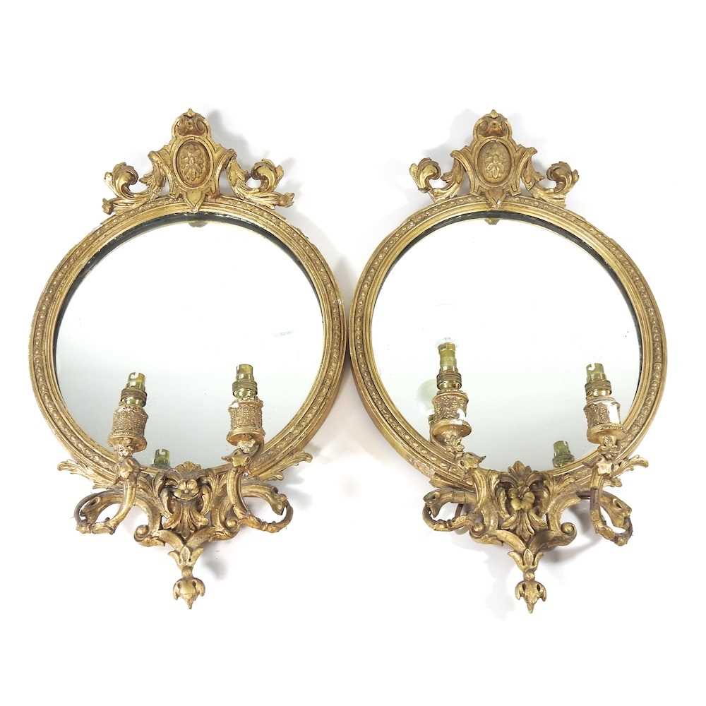 A pair of 19th century carved pine and gilt gesso framed girandole, each with two scrolled