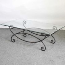 A glass top coffee table, on an iron base 170w x 120d cm