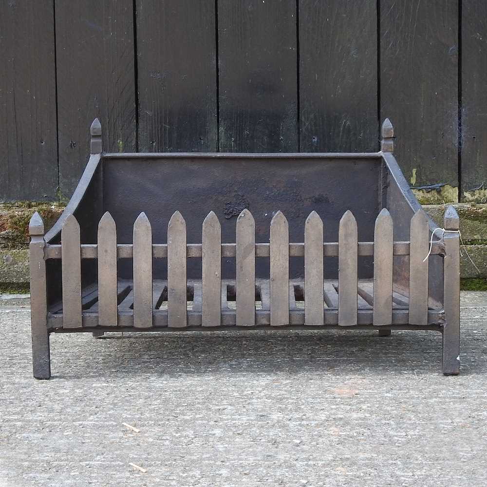 A cast iron fire grate 66w x 30w x 38d cm