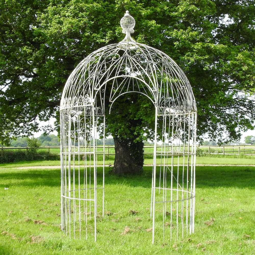 A large white painted wirework garden pergola, of circular shape, with a domed top 200w x 310h cm