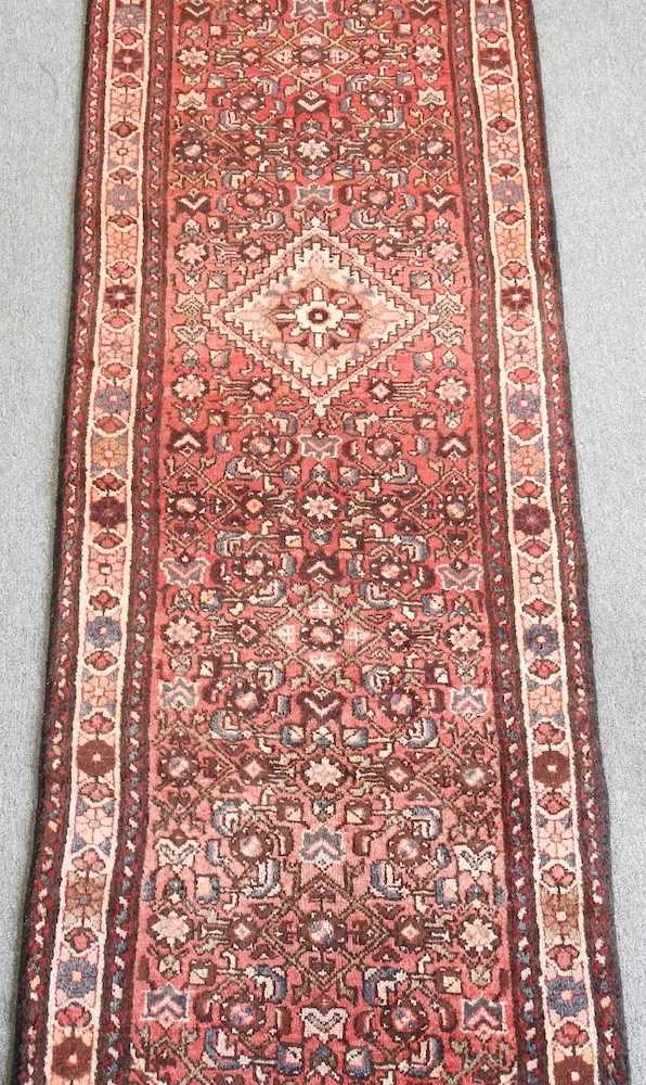 A Persian malayer runner, with flowerhead motifs, on a red ground, 308 x 85cm - Image 3 of 5