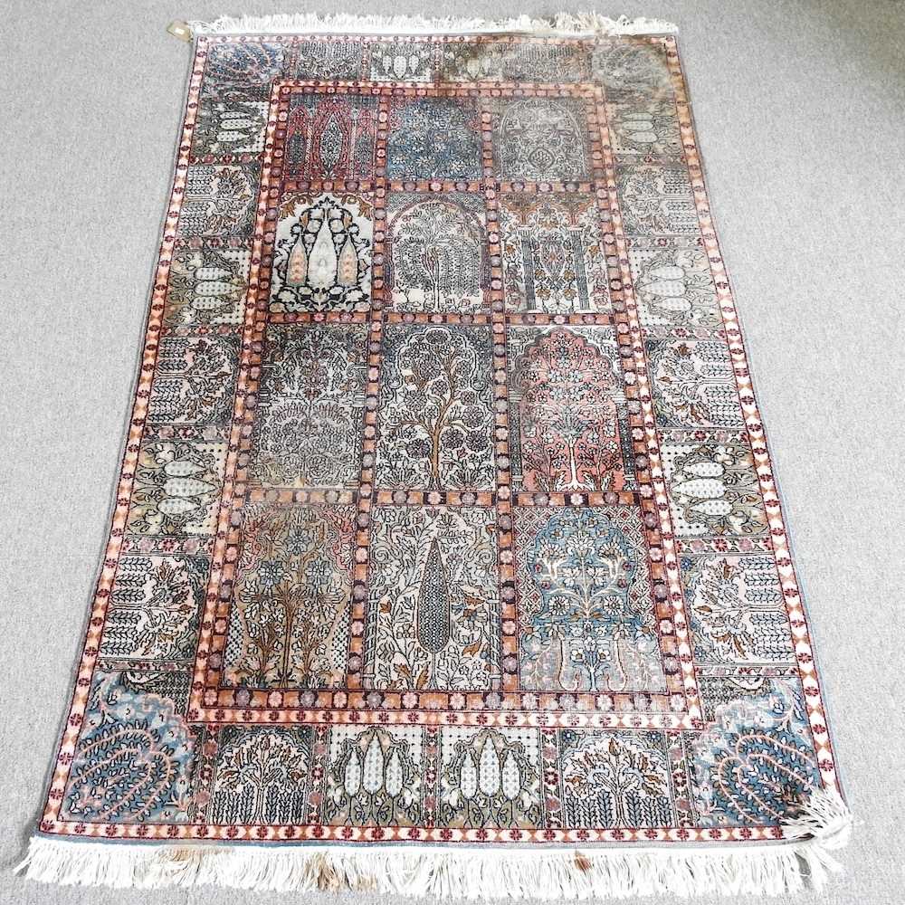 A small Persian part silk rug, with foliate decoration, 200 x 120cm