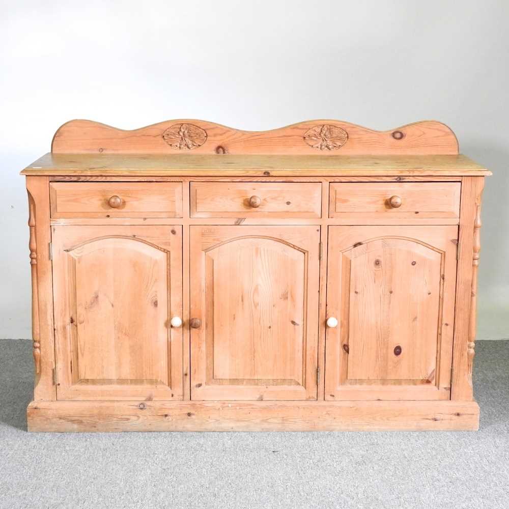 A modern pine sideboard, with a shaped gallery back 136w x 41d x 92h cm
