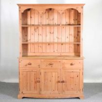 A modern pine dresser, with an arcaded back, with drawers and cupboards below 143w x 200h x 43d cm