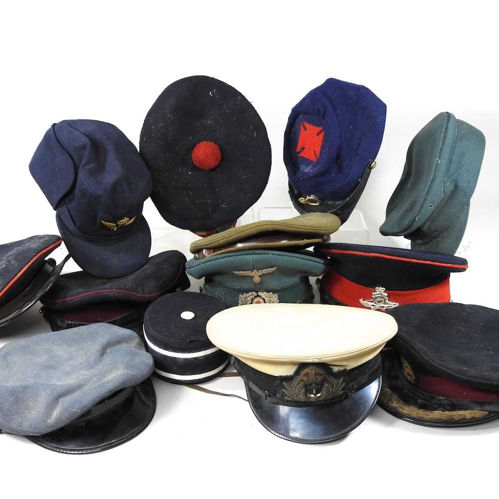 A collection of various military and uniform caps, German and other ephemera etc
