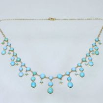 A turquoise fringe necklace, set with graduated stones, on a fine chain, unmarked, 14g, 38cm long