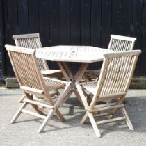 A teak folding garden table, 99cm diameter, together with a set of four matching garden chairs (5)