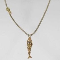 A gilt flexible link necklace, with a clasp in the form of a hand, wearing an emerald ring, 46cm