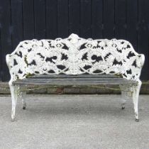 An ornate white painted cast iron Coalbrookdale style garden bench, of fern design, with a slatted