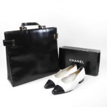 A Gucci black leather tote handbag, with authentication, together with a pair of Chanel cream canvas