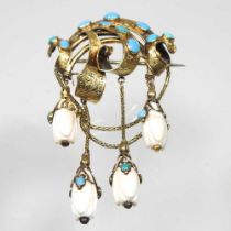 A 19th century gilt and turquoise brooch, of scrolled wave design, suspended with four white coral