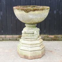 A large cast stone garden font, of circular shape, on a plinth base and associated stand, 120cm high