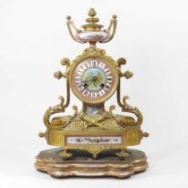 A French gilt metal and porcelain mounted mantel clock, with an eight day movement, on a plinth