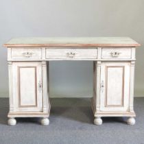 A continental white painted pine pedestal desk, on turned feet 131w x 70d x 82h cm