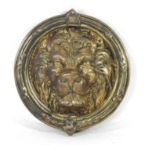A large brass lion mask door knocker, 22cm diameter