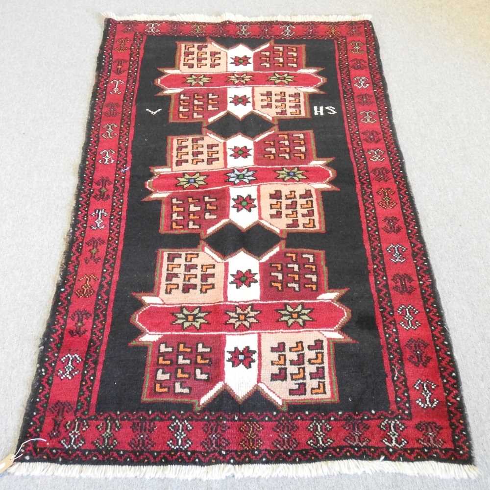 A Baluch rug, with three central medallions, 190 x 120cm