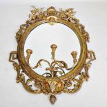 A good large 19th century carved wood and gilt gesso girandole, of oval shape, with a moulded