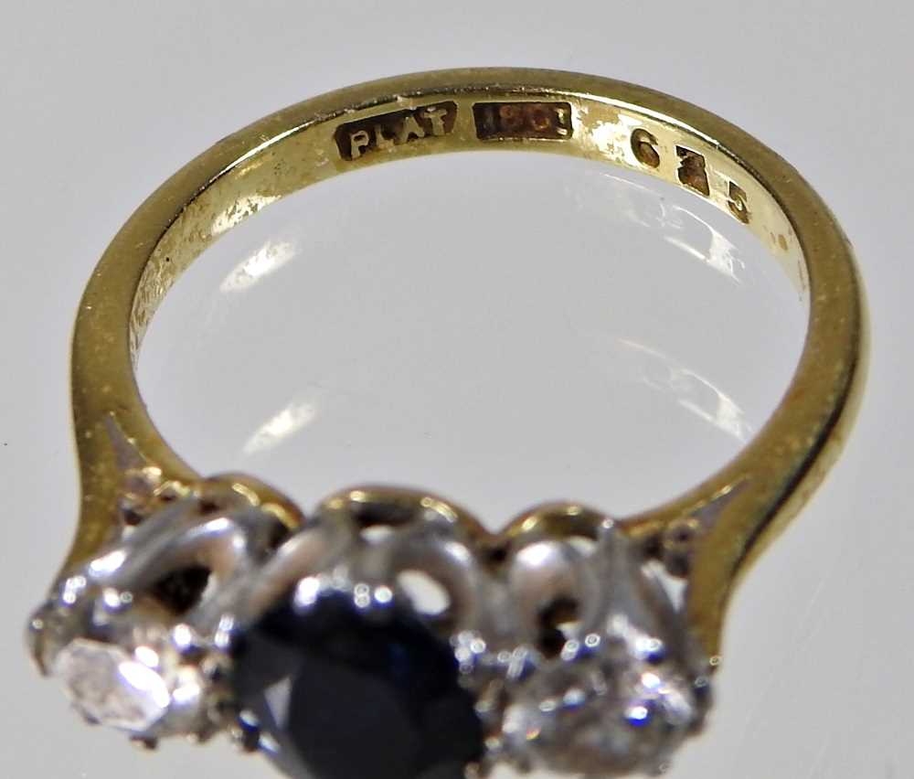 An 18 carat gold, sapphire and diamond three stone ring, the central oval sapphire, flanked by a - Image 5 of 7