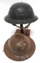 Two WW2 Home Front Helmets consisting a child's brown painted, pressed steel helmet with crinkle