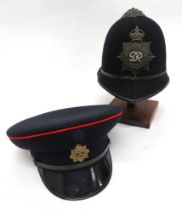 Metropolitan Police Helmet And Military Cap black, two panel crown.  Pointed peak and rounded rear