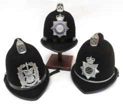 Three Various Post 1953 Constabulary Helmets consisting black crowns with top combs.  Front plated