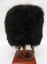 Guards Pattern Busby black fur body.  Inner wickerwork frame.  Black leather, eight tongue