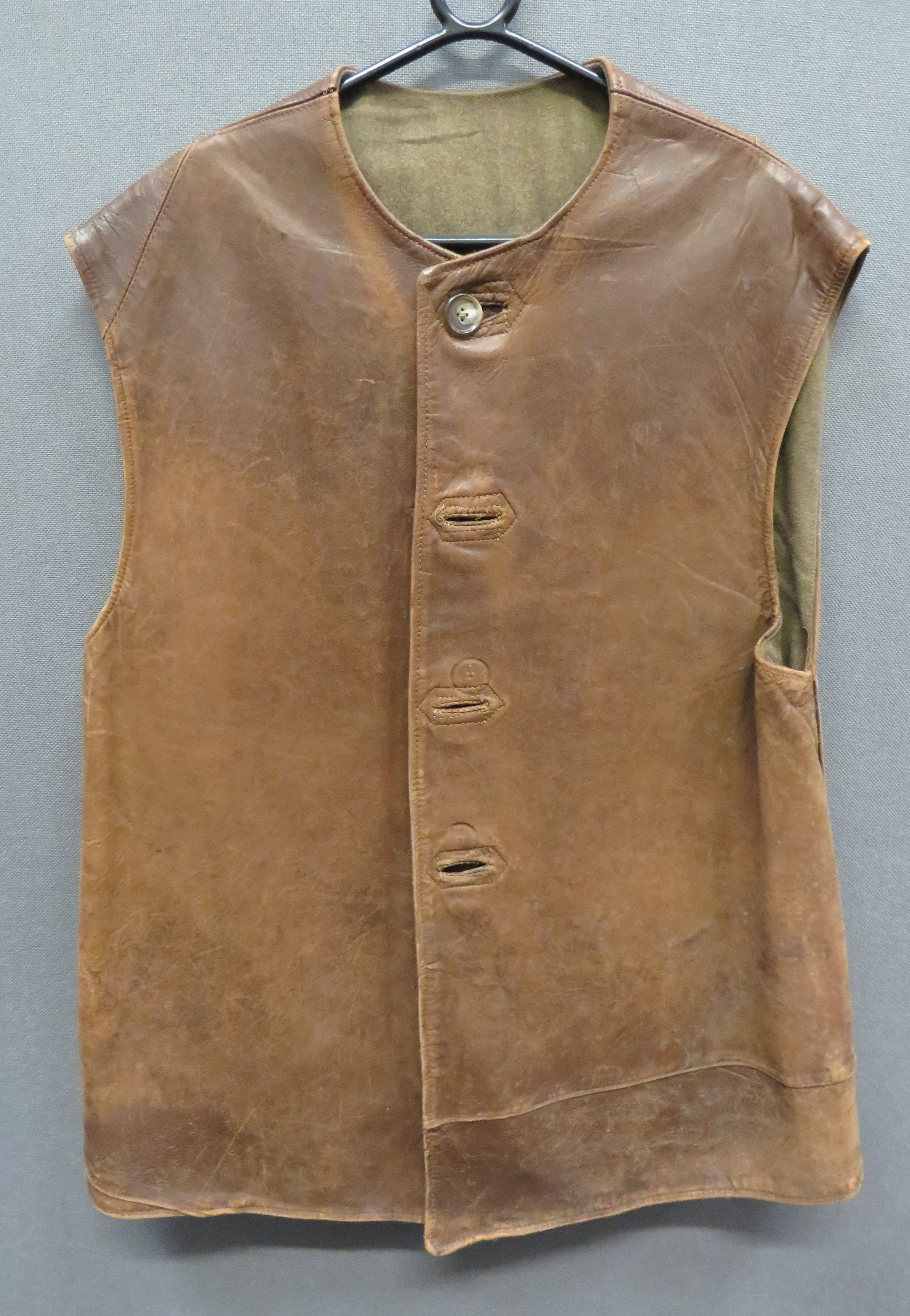 WW2 Dated Leather Jerkin brown leather, multi panel, sleeveless jerkin.  The front fastened by