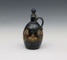 A Royal Doulton Art Nouveau style stoneware whiskey flask relief decorated, factory marks beneath,