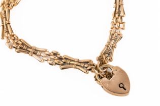 A 9ct rose gold bracelet the bracelet fastened with a heart lock clasp.