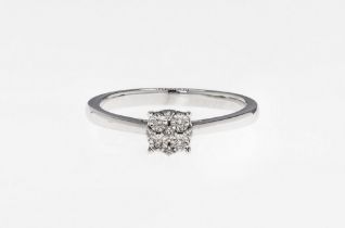 A 9ct white gold and diamond cluster ring featuring 4 chip diamonds held in an illusion setting,