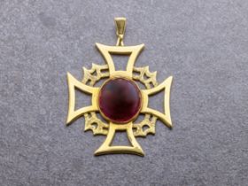 A 9ct gold and garnet Maltese cross with cabochon cut garnet to the centre and bark-effect detailing