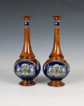 A pair of Doulton Lambeth sprinkler vases the blue reserves with moulded decoration to a brown