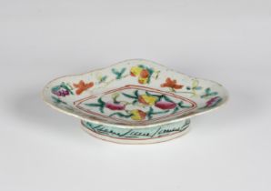 A Chinese famille rose stem / footed dish early 20th century, of lozenge form, painted with