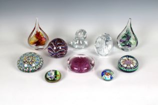 A collection of glass paperweights to include two Poland teardrop paperweights with original