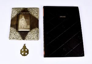 A Queen Victoria souvenir photograph frame of sloping rectangular form with pierced metal mounted