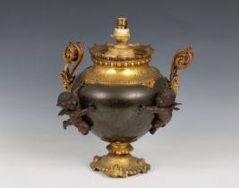 A French late 19th century patinated bronze and gilt metal urn lamp with cherubs (converted)