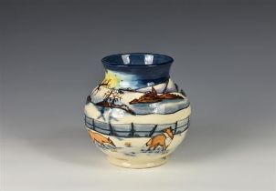 A Moorcroft Woodside Farm pattern baluster vase dated 1999, decorated with foxes in a snowy