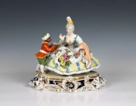 A Meissen style porcelain figural group of a seated lady and servant having blue cross sword mark