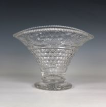 A cut glass footed vase of ovoid form with a flared rim on a circular base scrolling and floliate