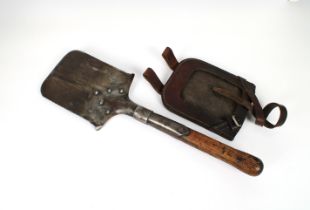 A WWI entrenching tool / spade saw edge, the blade stamped with 1903 and many proof marks, leather